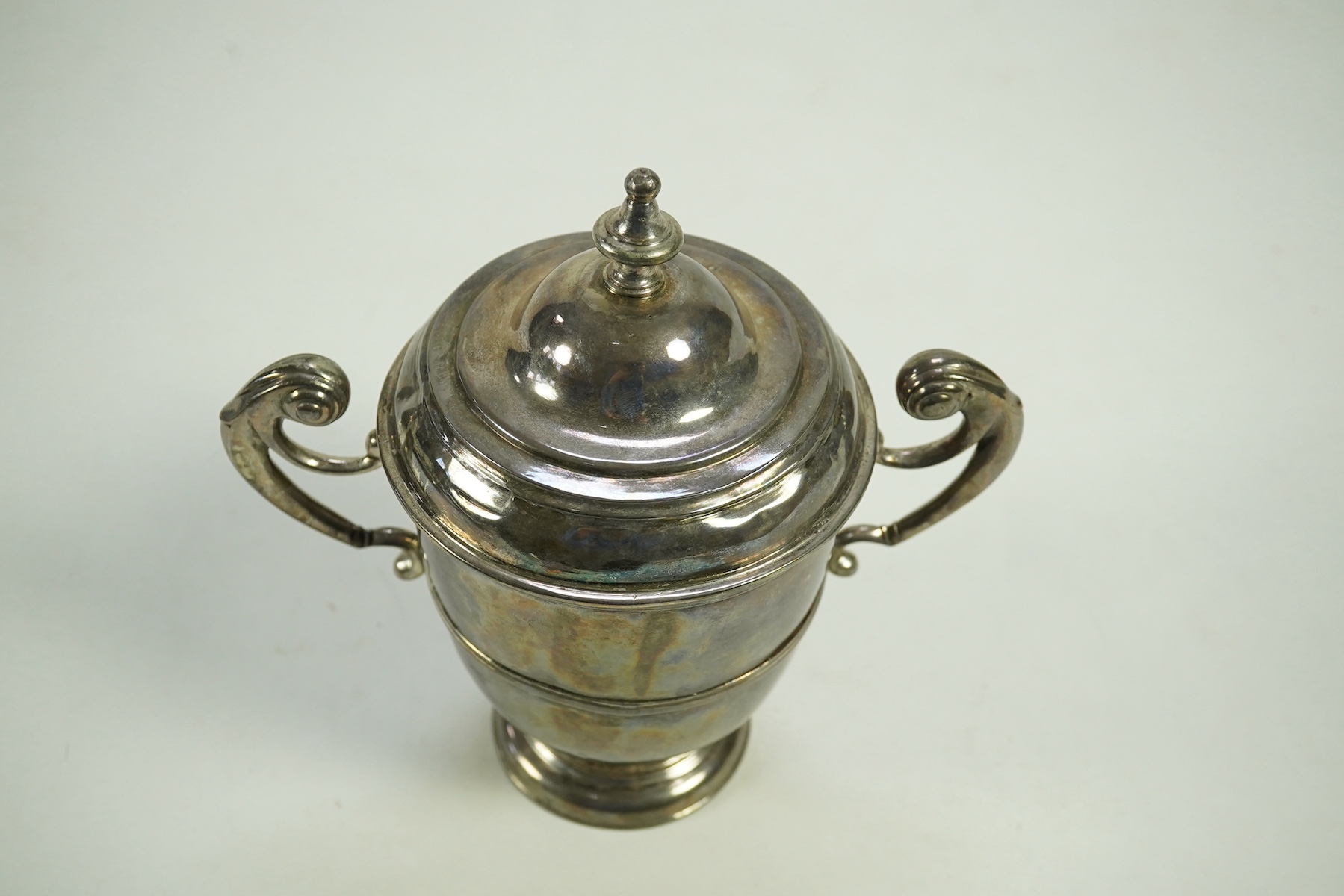 A George I Irish silver two handled cup by Philip Kinnersley, Dublin, 1719, with an earlier Queen Anne matched Irish silver cover by Joseph Walker, Dublin, 1704